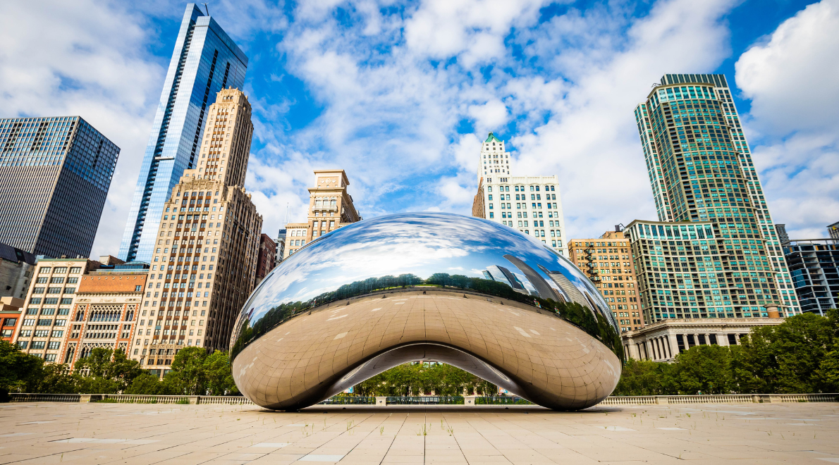Ground-level perspective of Cloud Gate - An otherworldly reflection of the cityscape in polished steel. The concave, mirror-like surface captures the essence of Chicago's skyline from a unique angle, distorting and melding the surroundings as if bending reality itself. The seamless integration of art and urban environment invites viewers to engage in a captivating visual dialogue.