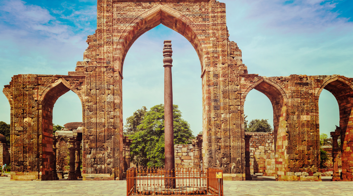 Close-up image of the Iron Pillar - A testament to ancient metallurgical craftsmanship. The rust-resistant iron column stands tall against time's embrace, adorned with intricate textures and patterns, whispering stories of its centuries-old journey