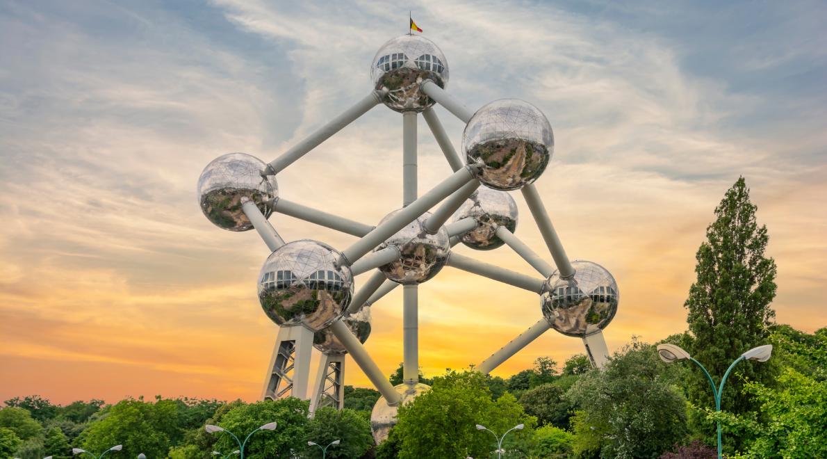 The Atomium seen from above the trees set against a golden sunset