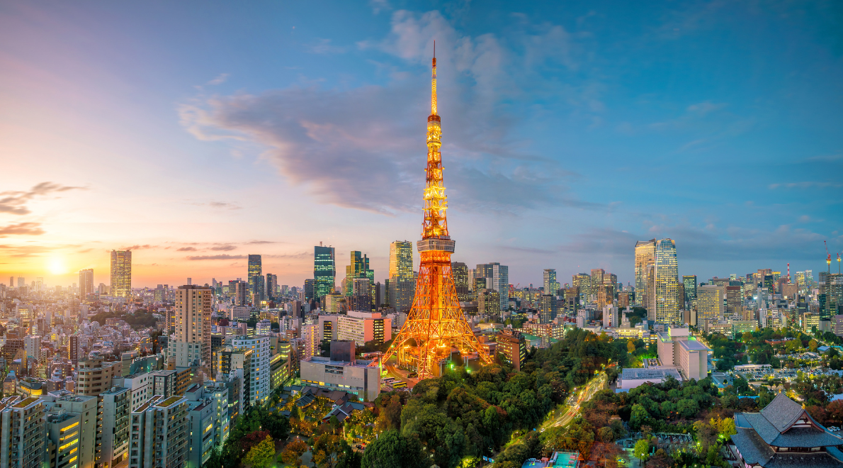 Panoramic vista of Tokyo Tower against the sprawling cityscape - A luminous orange beacon amidst the urban tapestry. The tower's lattice structure stands tall, gracefully punctuating the skyline as it overlooks the vibrant city lights, a modern testament to Tokyo's fusion of tradition and innovation.